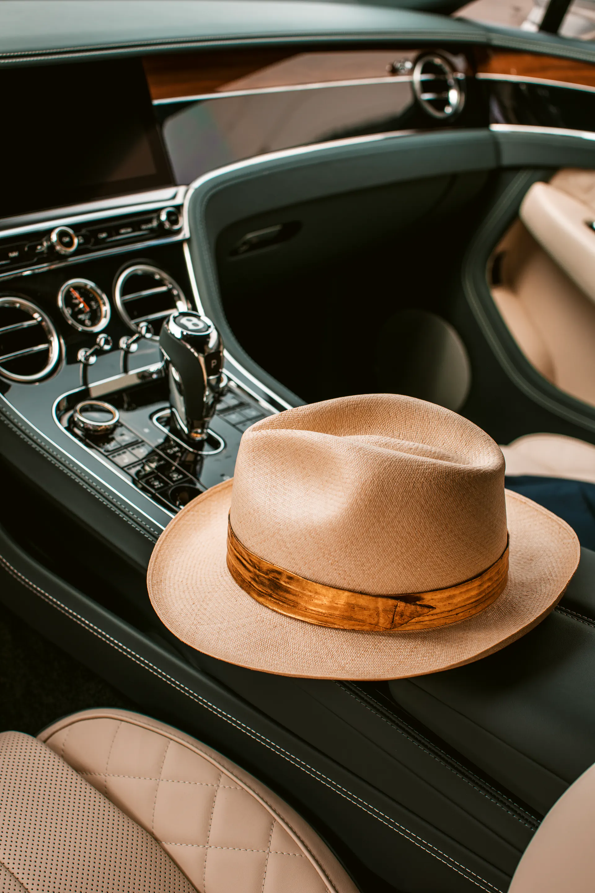 Goldish Panama hat inside a Bentley interior